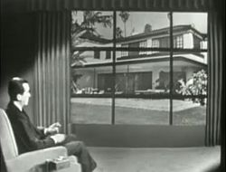 Edward Murrow at left as home of movie star Kirk Douglas is shown on studio screen, 1957.