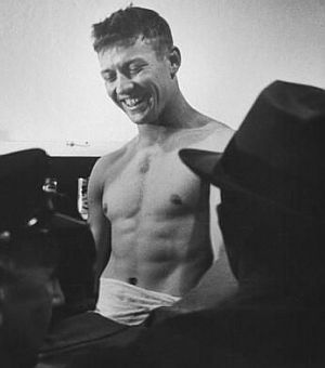 Mickey Mantle – here in his young “Greek god” body – captured by Life magazine during a celebratory locker room scene, October 1952.