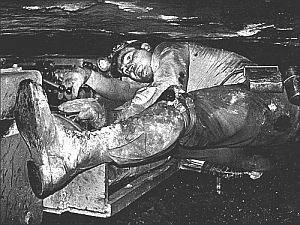 Miner working in a confined, cramped position inside a narrow coal seam on a piece of equipment called a ‘lizard.’  (photo, Earl Dotter. Click for book of his coal photography).