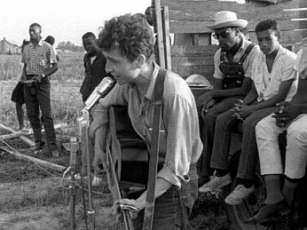 July 1963: Bob Dylan at civil rights gathering in Greenwood, Mississippi singing ‘Only a Pawn in Their Game,’ a song about the murder of activist Medgar Evers.