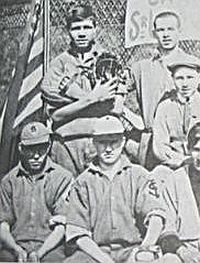 Ruth shown, top left, in 1910s-era St. Mary’s team photo, with catcher’s mitt and fielder’s glove, as he both caught and pitched for St. Mary’s. Click for photo.
