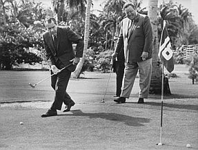 Nixon with Jackie Gleason on golf course.