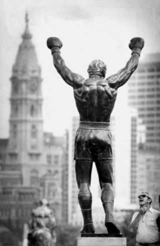 Statue of the famed Rocky Balboa character from the ‘Rocky’ film series, shown here in the early 1980s, in its much-disputed ‘top-of-the-steps’ perch at the Philadelphia Art Museum, looking out on center city. Photo, Vicki Valerio, Philadelphia Inquirer, July 1982.
