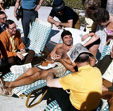Joe Namath, poolside, January 10, 1969, talking with reporters about his prediction that the Jets would beat the Colts in the January 12th Super Bowl. Photo, Walter Iooss Jr./Sports Illustrated.