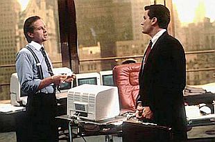 Gordon Gekko and Bud Fox in Gekko’s office looking out on a New York city skyline. Click for promotional photo.