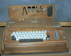 An Apple I computer with a custom-built wood housing with keyboard.
