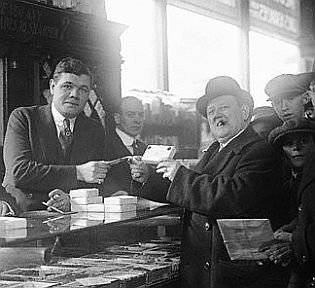 Babe Ruth shown making a cigar sale at Boston tobacco shop, February 1920.