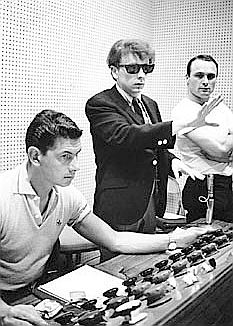 Phil Spector in recording studio, circa 1960s, with engineer Larry Levine, seated.