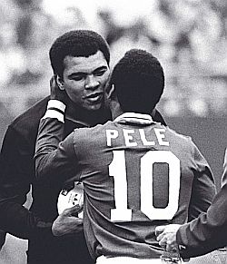 Pelé embracing boxer Muhammad Ali during ceremony honoring Pelé, then with NY Cosmos, at Giants Stadium, N.J., Oct 1, 1977. In final game, Pelé played a half on each side: Cosmos 2, Brazil Santos 1.
