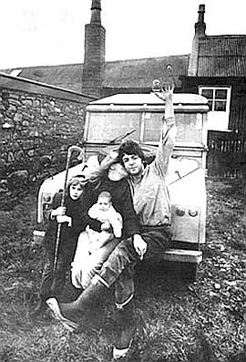 Paul McCartney getting a kiss from wife Linda as they sit on bumper of Range Rover with baby Mary and Linda’s daughter Heather at their farm in Scotland. Photo, Life, 1969. Click for Paul & Linda's 'Ram' album.