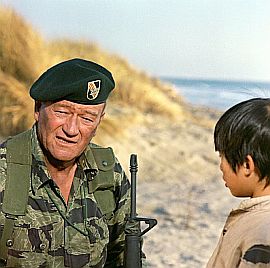 John Wayne with young Vietnamese boy, Hamchunk, in part of final scene from 1968 film, “The Green Berets.”