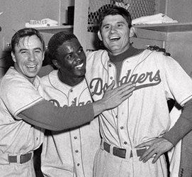 Pee Wee Reese, Jackie Robinson, and pitcher “Preacher” Roe celebrating after beating the New York Yankees in game 3 of the 1952 World Series.