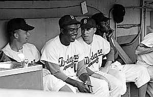 Sept 1953: Jackie Robinson & Pee Wee Reese, center, in the Brooklyn Dodgers dugout. Look Collection, U.S. Library of Congress.