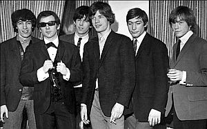 Mid-1960s: Rolling Stones shown with wunderkind studio producer, Phil Spector, with sunglasses.