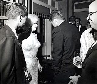 Robert F. Kennedy, Marilyn Monroe, and John F. Kennedy in rare photo taken at private “after party,” May 19, 1962. Advisor Arthur Schlesinger, with glasses, shown at right. 
 Photo, Cecil Stoughton