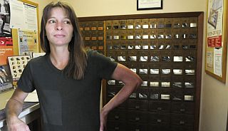 Kim Billington of Waverly, WA, a city council member, at her town's post office which serves 100 residents in southern Spokane County. Billington says the post office is the only building in town that is staffed every day.  Photo, AP.