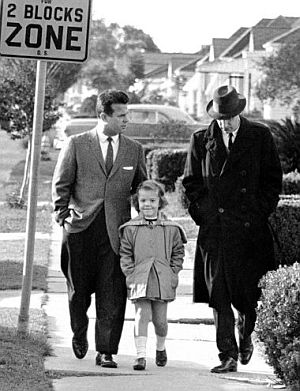 Nov 29, 1960: White parent, Rev. Lloyd Foreman (left) walks his five-year-old daughter Pam to the newly integrated William Frantz School where they were blocked by jeering crowd. At right is AP reporter Dave Zinman. AP photo.