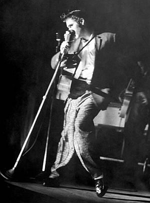 Elvis Presley performing on stage at the Florida Theater in Jacksonville, Florida, August 10th, 1956.