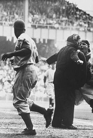 1955: Jackie Robinson “safe,” says the umpire, as Yogi Berra argues the call. Photo, Grey Villet.