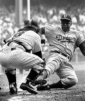 Famous photo of Jackie Robinson stealing home as Yogi Berra applies the tag. Photo, Mark Kauffman. Click for framed print.