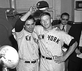 Yogi Berra and Mickey Mantle with reporters following a game in the 1950s.
