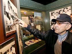 Dec 2009: Yogi Berra pointing out some detail at one of the exhibits at his baseball museum in Little Falls, NJ. Bergen Record photo.
