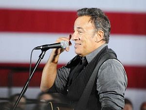 Nov 2012: Bruce Springsteen sharing a joke with audience at Des Moines, Iowa rally about late-night Obama phone calls.
