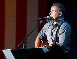 Bruce Springsteen performing with acoustic guitar at Obama rally in Parma, Ohio.