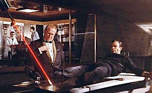 Goldfinger tells James Bond he is about to die by way of an industrial laser slicing him in two, but Bond gains a reprieve by letting on he knows more than he does.