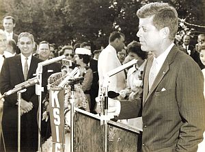 Oct 1959: JFK speaking at the Int’l Rice Festival in Crowley, LA where he and Jackie were hosted by Judge Edmund Reggie, at left, dark suit.  E. Reggie Archive.