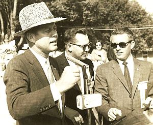 Oct 1959: JFK, who generally avoided donning gift hats of any kind, shown here in a “rice hat” awarded him at the Int’l Rice Festival in Crowley, LA. Edwin Edwards, later governor, shown at far right. Edmund Reggie archive.