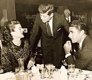 1959: JFK talking with his sister, Patricia Kennedy Lawford and her husband, Peter Lawford, at unidentified restaurant.