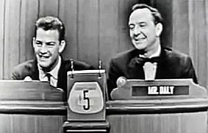 Dec. 1956: Frank Gifford with TV show host, John Daily, taking questions from celebrity panel trying to guess Gifford’s line of work on quiz show,“What’s My Line?”