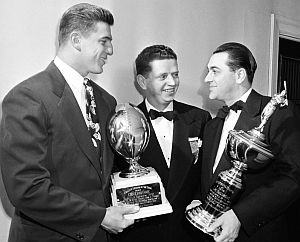 Jan 31, 1949: Chuck Bednarik, left, and Lou Boudreau of the Cleveland Indians baseball team, far right, collecting trophies for their play from the Philadelphia Sports Writers Association.  Jack Wilson center (AP photo).