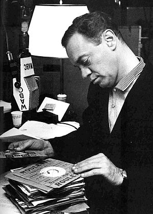 1958: Alan Freed, going through a stack of 45rpm records at WABC radio station in New York.