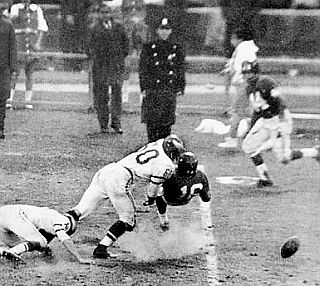 Chuck Bednarik’s tackle of Frank Gifford, as the ball pops out far right, during Eagles-Giants game of Nov 20th, 1960.