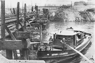 June 23, 1969: Photo of fire boat attending to hot spots and bridge timbers following Cuyahoga River fire the day before.