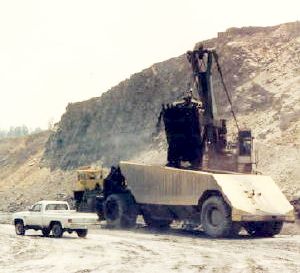 A Peabody “loader,” a smaller shovel, loading coal from a Sinclair Mine pit into a 100-ton capacity coal haulage truck for the Paradise Power Plant, circa 1960s-1970s.