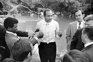 June 23, 1969: Cleveland Mayor Carl Stokes, center, and Ben Stefanski, city utilities director, right, during press conference near site of previous day’s Cuyahoga River fire.