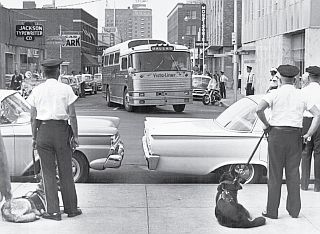 Jackson, Mississippi police line city streets near the bus station as Freedom Riders arrive there in May 1961.