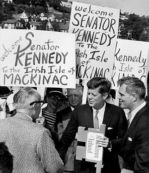 June 3, 1960: In Michigan, Mackinac Islanders welcome JFK, awarding him a key to the island. Gov. Williams introduced JFK to the crowd. Photo, Detroit News