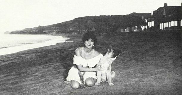 May 1978: Linda Ronstadt with canine friend on the Malibu, California beach near her home, reportedly a location frequented by Jerry Brown who was fond of long walks along the beach. 