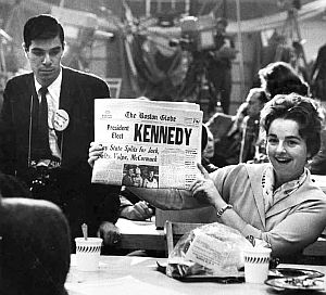 November 9, 1960: Member of the press who gathered at the Hyannis Armory through the long election night, displays a Boston Globe headline proclaiming Kennedy’s victory.  Henri Dauman photo from the Taschen Mailer-Kennedy book.