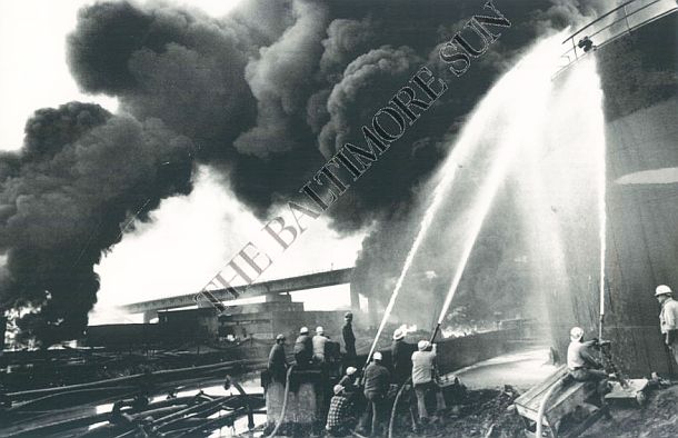 Associated Press wire photo used by The Baltimore Sun showing firemen still battling one of the tank fires at the Gulf Oil refinery in Philadelphia, PA on Monday, August 18, 1975, a day after the fire had started.  “Flare ups” at the site would continue for another week following the original inferno.