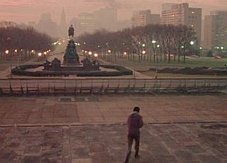 With the Benjamin Franklin Parkway in view, Rocky, still winded, reaches the bottom of the steps, now heading home.