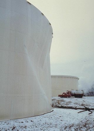 Nearby tank damaged by the force of escaping oil from collapsed tank at Ashland’s Floreffe complex. Photo, NOAA. 