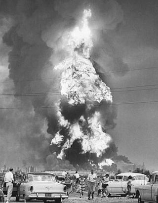 August 1955: Onlookers watching the refinery blaze from a distance were surprised by a subsequent explosion and ran for their cars. Life magazine, Sept 5, 1955, Wallace Kirkland.