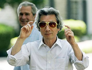 July 2006: Prime Minister Koizumi with Elvis sunglasses outside Graceland mansion as President Bush looks on. 