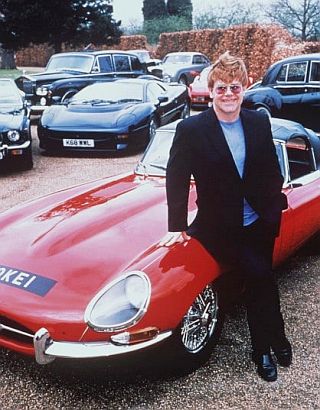 Elton John with some of his car collection, circa 2001.