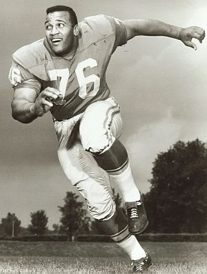 On one play, Plimpton was met in the backfield by giant 300-pound  defender, Roger Brown, who threw him for a loss and nearly forced a fumble for a touchdown. 